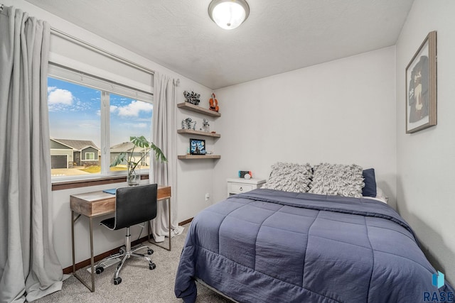 carpeted bedroom featuring a textured ceiling