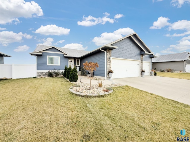 view of front of house with a front yard and a garage