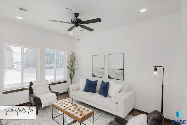 living room featuring ceiling fan and light hardwood / wood-style flooring