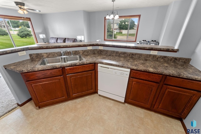 kitchen with white dishwasher, hanging light fixtures, a healthy amount of sunlight, and sink