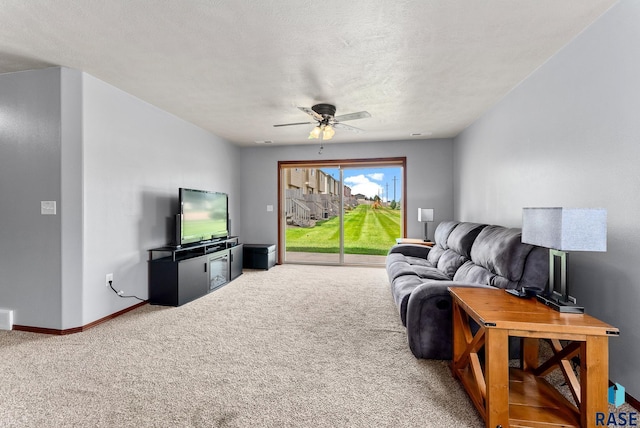 carpeted living room featuring a textured ceiling and ceiling fan