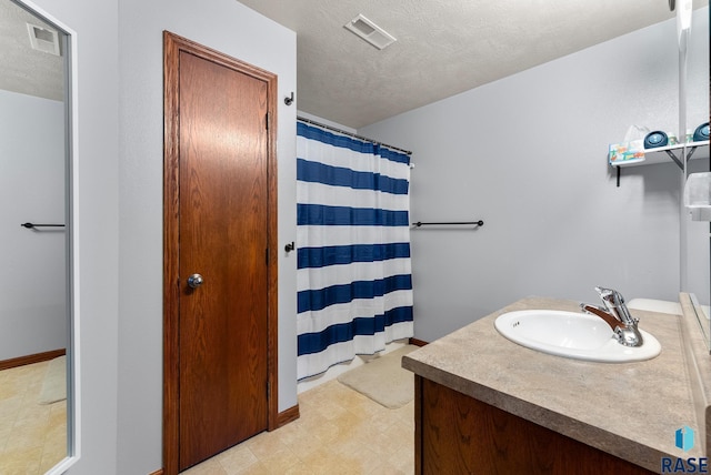 bathroom with vanity and a textured ceiling