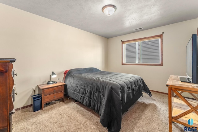 carpeted bedroom featuring a textured ceiling