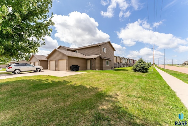 view of front of property with a front yard and a garage