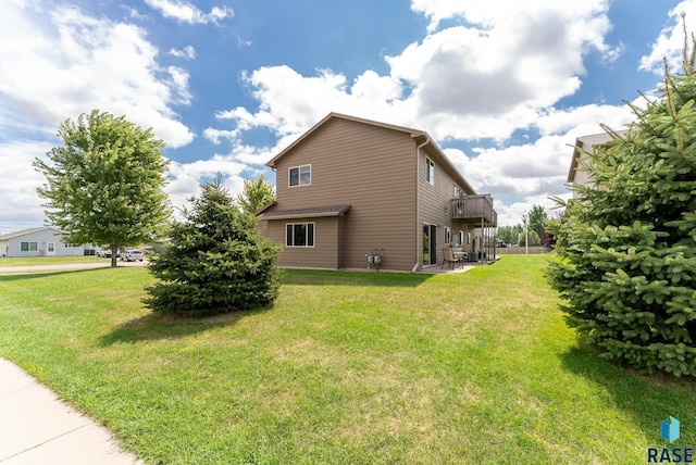 view of side of property with a lawn and a deck