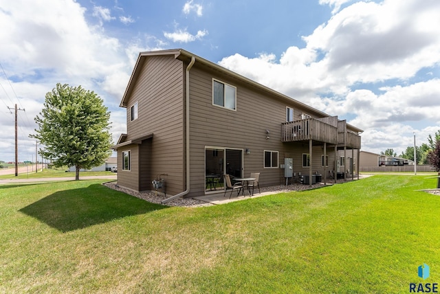 back of house with a patio area and a yard