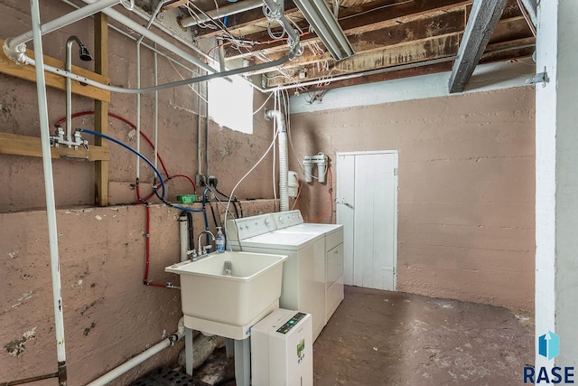 washroom featuring washing machine and dryer and sink