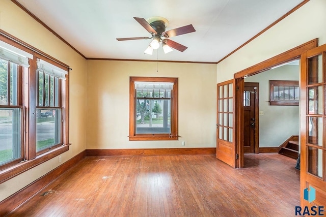 unfurnished room with french doors, ceiling fan, ornamental molding, and wood-type flooring