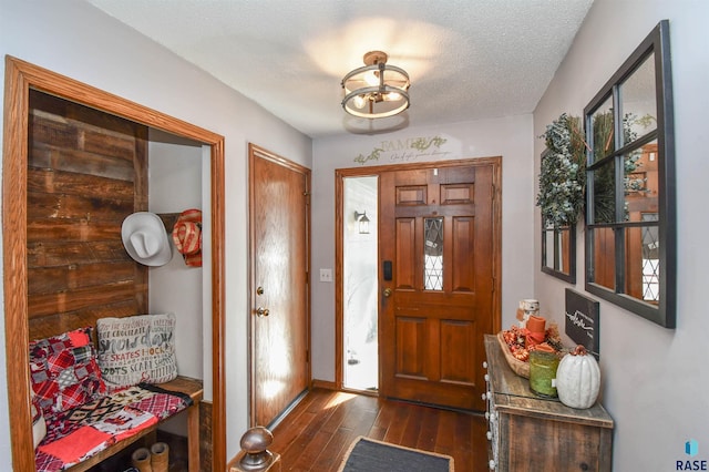 entryway featuring dark hardwood / wood-style flooring and a textured ceiling