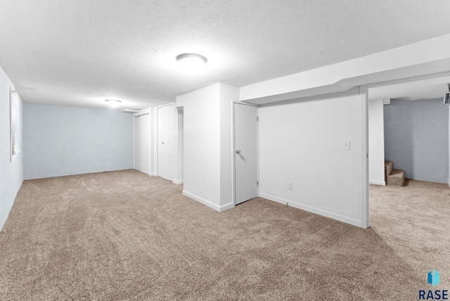 basement with light carpet and a textured ceiling