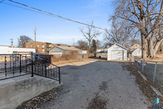 view of yard featuring a garage and an outdoor structure