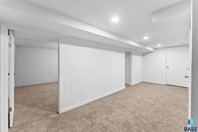 basement featuring light carpet