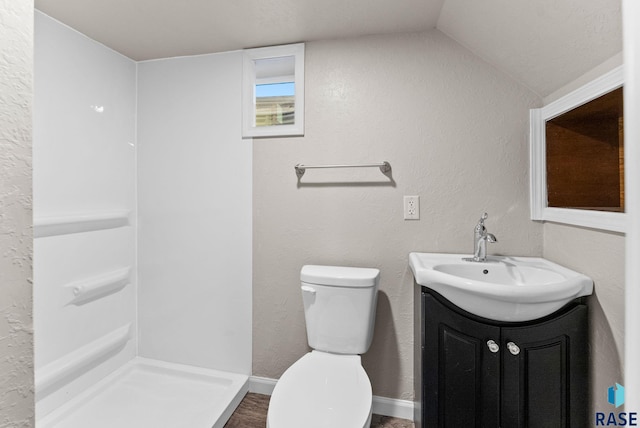 bathroom with vanity, toilet, and vaulted ceiling