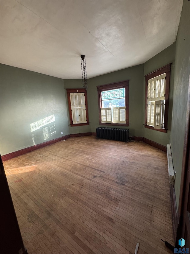 interior space featuring radiator heating unit and wood-type flooring