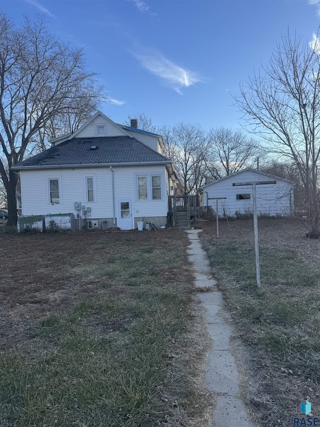 back of property with a yard