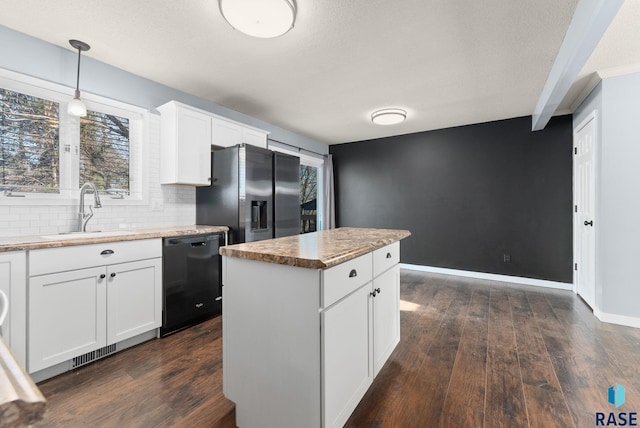 kitchen featuring a kitchen island, refrigerator with ice dispenser, decorative light fixtures, dishwasher, and white cabinetry