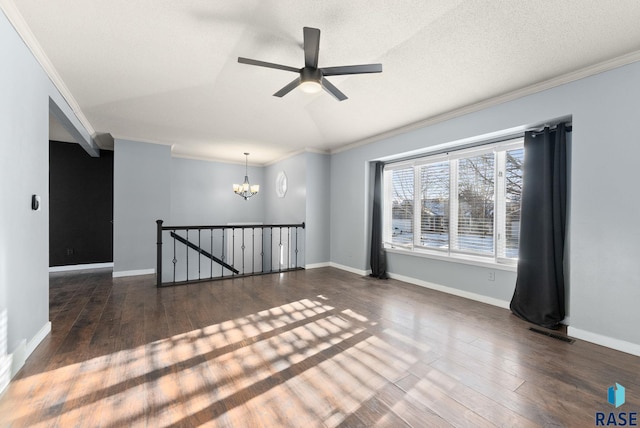 empty room with crown molding, dark hardwood / wood-style flooring, and vaulted ceiling