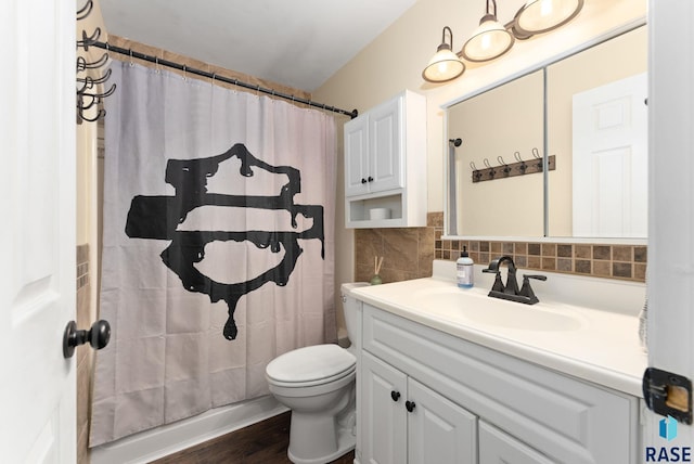 bathroom featuring hardwood / wood-style floors, vanity, toilet, and tasteful backsplash