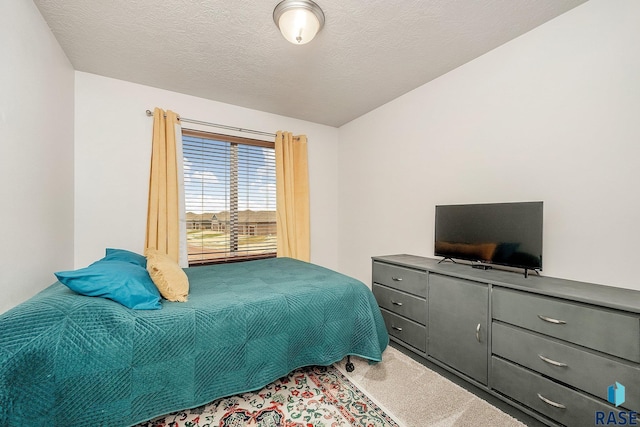 carpeted bedroom featuring a textured ceiling