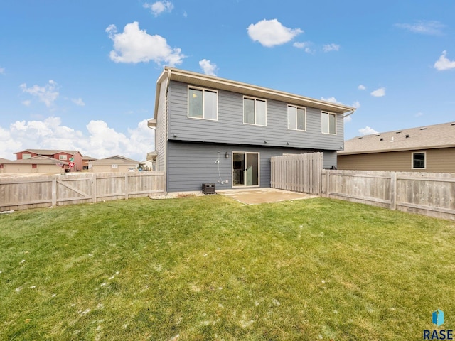 back of property featuring a lawn and a patio