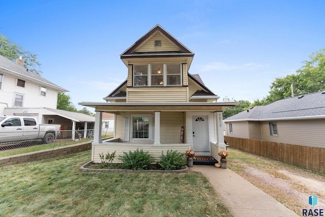 view of front of home with a front yard and a porch