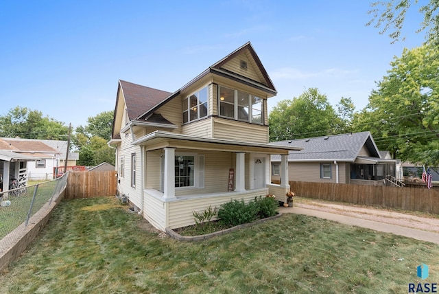 view of front of home with a porch and a front yard