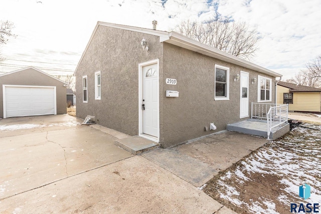 view of front of property with a garage and an outdoor structure