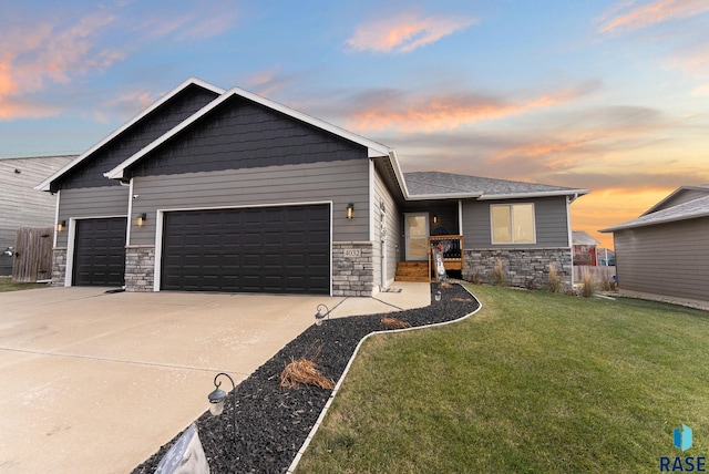 view of front of home featuring a lawn and a garage