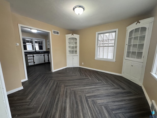 spare room with dark parquet floors