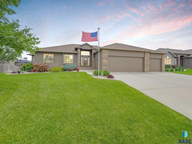 view of front of home featuring a garage and a lawn