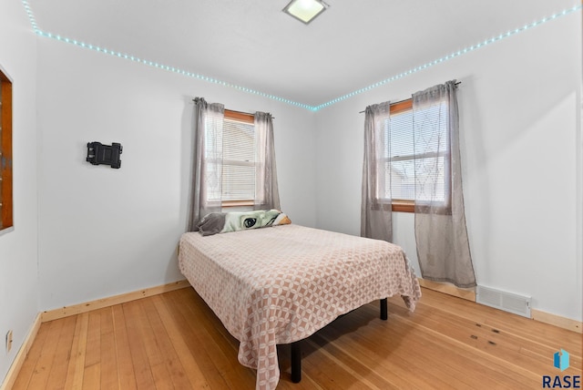 bedroom with hardwood / wood-style flooring