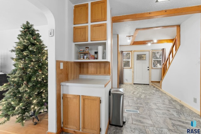 kitchen featuring beam ceiling and a textured ceiling