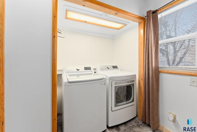 laundry room with independent washer and dryer and a wealth of natural light