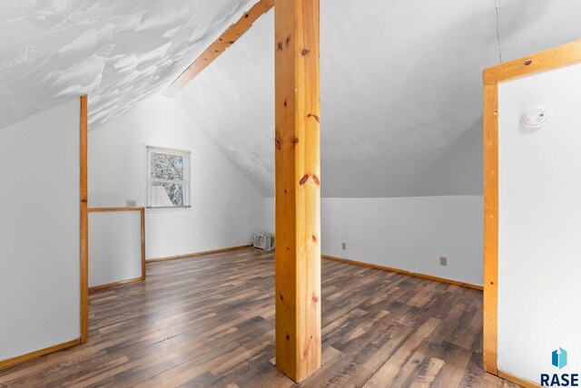 bonus room featuring dark hardwood / wood-style flooring and lofted ceiling