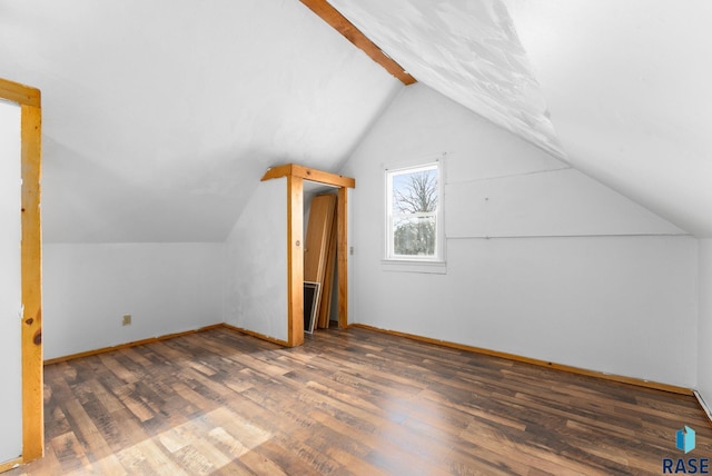 bonus room with vaulted ceiling with beams and dark hardwood / wood-style floors