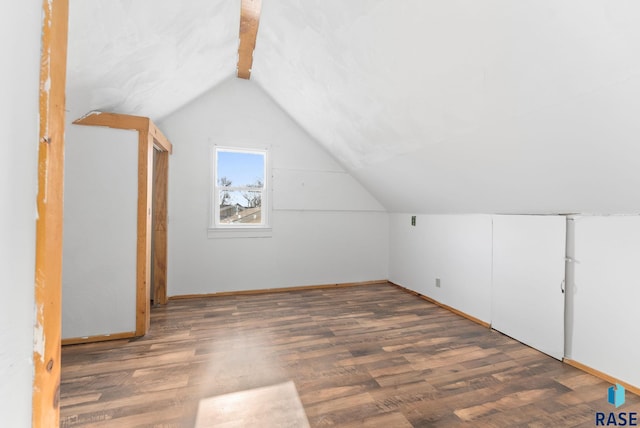 bonus room featuring lofted ceiling with beams and dark hardwood / wood-style flooring