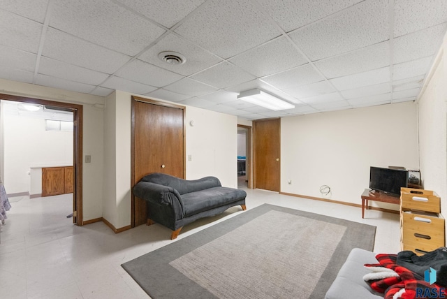 living room with a drop ceiling