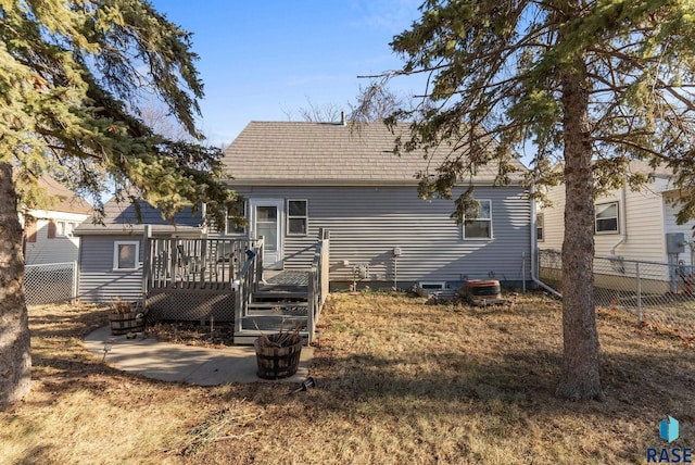 rear view of house with a wooden deck