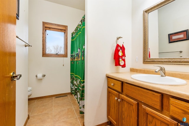 bathroom featuring tile patterned floors, vanity, and toilet