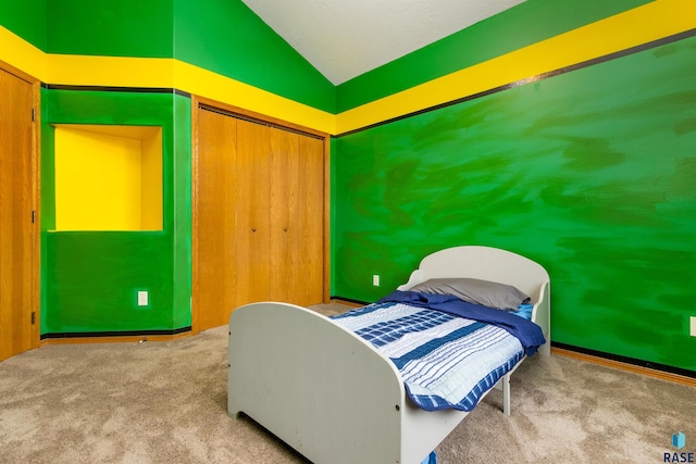 bedroom featuring light carpet, vaulted ceiling, and a closet