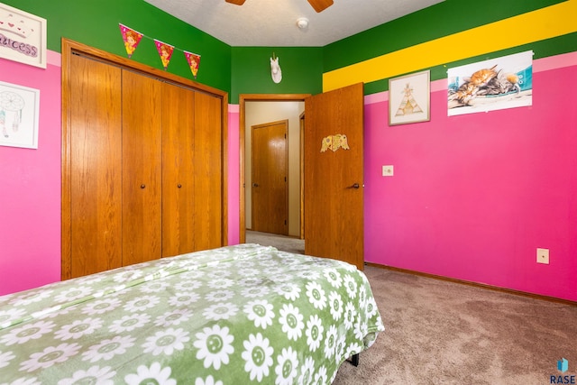 carpeted bedroom with ceiling fan and a closet