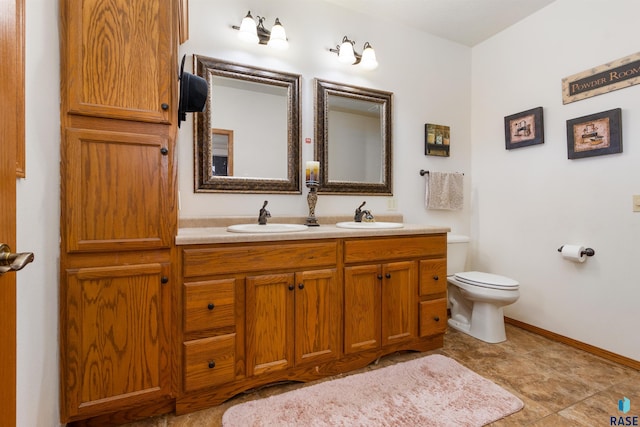 bathroom with tile patterned floors, vanity, and toilet