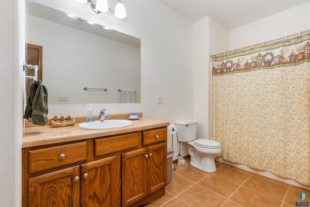 bathroom featuring toilet, vanity, and tile patterned floors