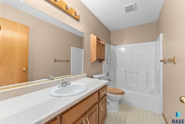 full bathroom with vanity, a textured ceiling,  shower combination, and toilet