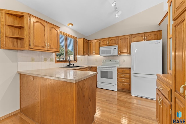 kitchen with sink, light hardwood / wood-style flooring, kitchen peninsula, lofted ceiling, and white appliances