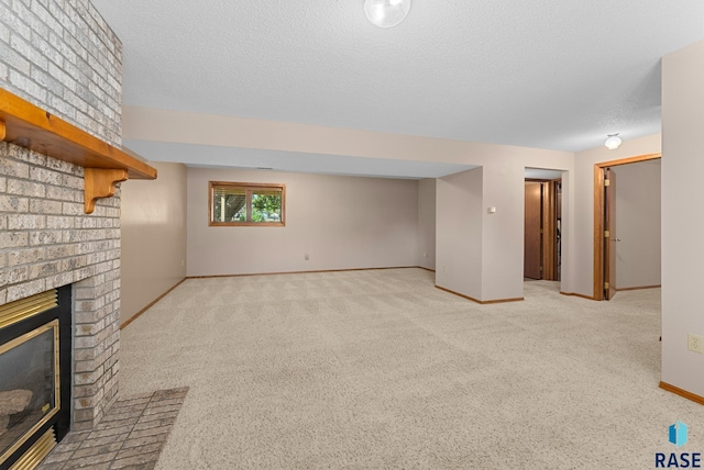 unfurnished living room with a fireplace, light colored carpet, and a textured ceiling