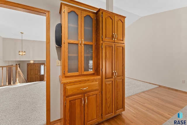 interior details with hardwood / wood-style floors and an inviting chandelier