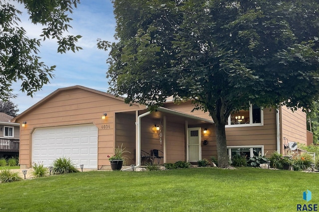 view of front of property with a garage and a front lawn