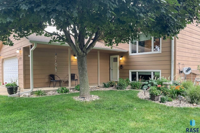 view of front of property featuring a garage and a front lawn