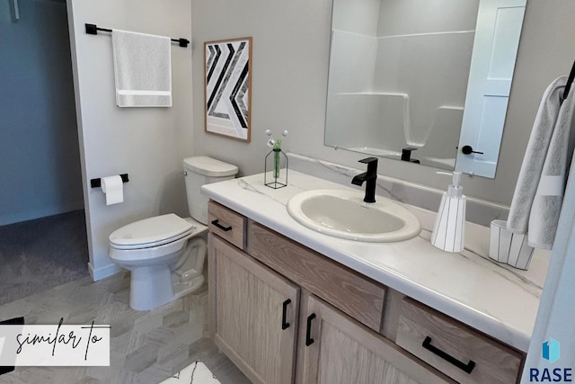 bathroom featuring vanity and toilet